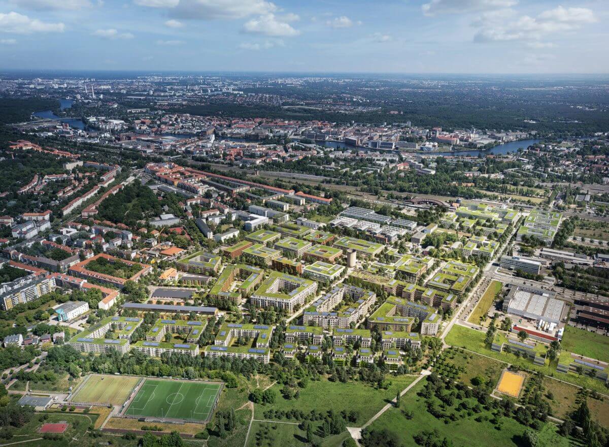 Vogelperspektive des geplanten Segelflieger Quartiers in Berlin-Johannisthal mit Wohnhäusern und viel Grün.